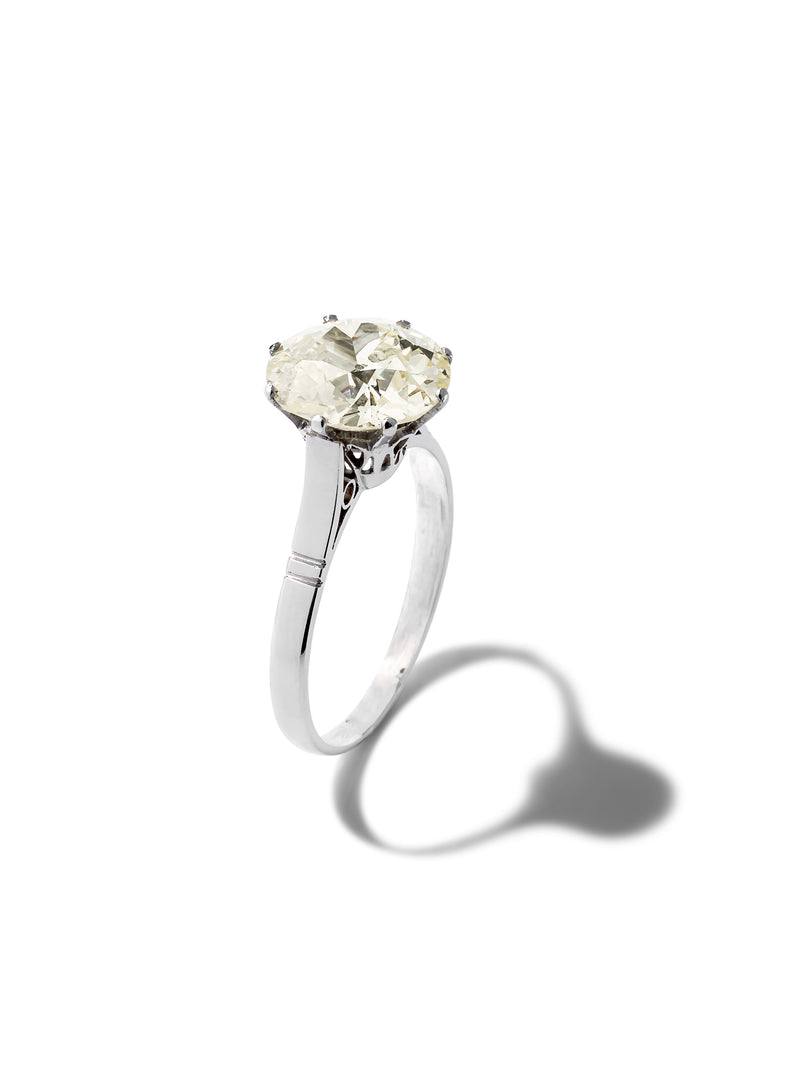 A silver-toned diamond ring with an oval-cut center stone, shown on a clean white background with a soft shadow.
